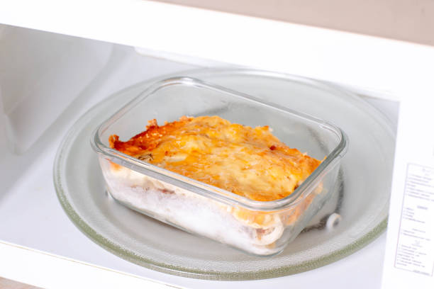 istock Potato casserole with meat in a container in the microwave. Ready meals 1290655173