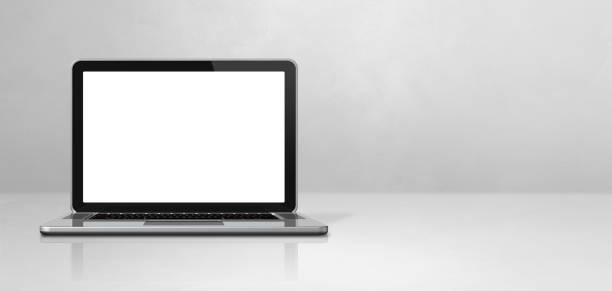 istock Laptop computer on white concrete office scene background banner 1290655234