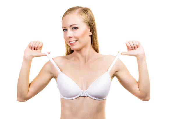 istock Young woman holding bra strap 1290655295