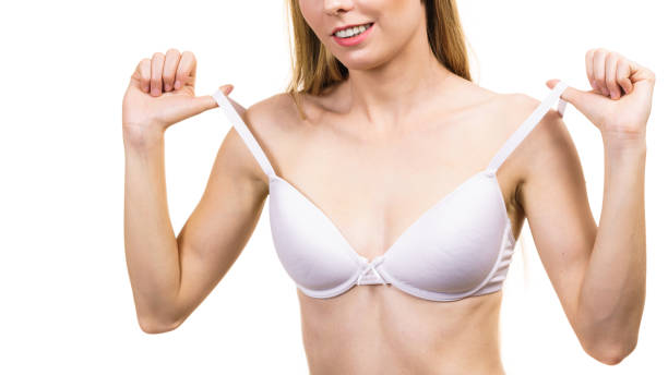 istock Young woman holding bra strap 1290655412