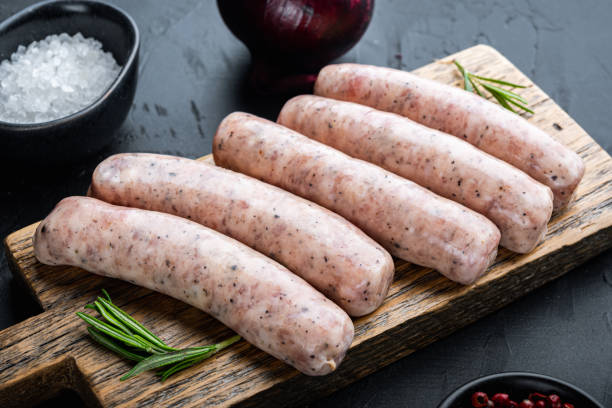 istock Traditional raw sausages, on black background 1290656283