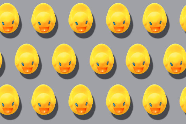 istock yellow rubber ducks on turquoise blue background 1290656562
