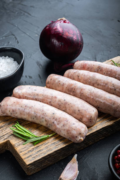 istock Traditional raw sausages, on black background 1290656883