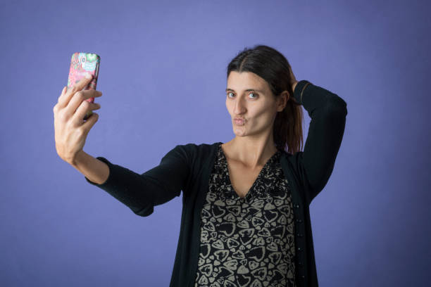 istock young woman taking a selfie with mobile phone 1290657941