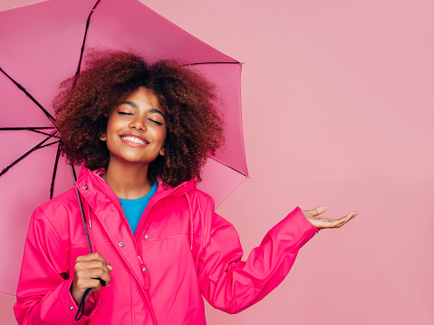 Afro girl with pink umbrella