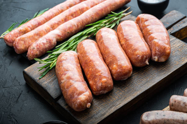 istock Homemade raw pork sausages, on black background 1290658670