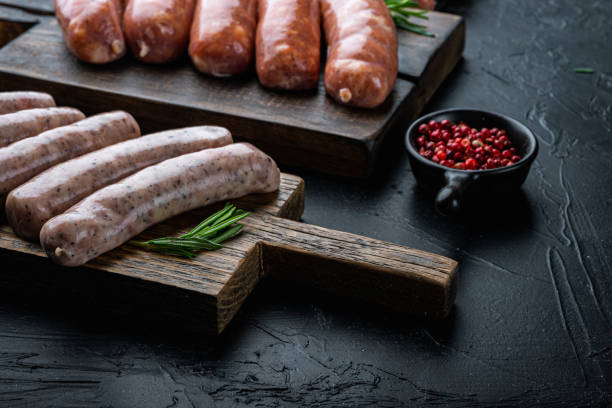 istock Traditional raw chicken sausages, on black background 1290658686