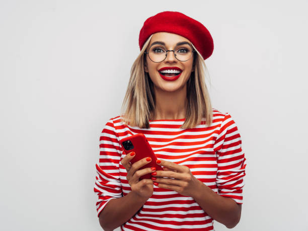 istock Beautiful smiling woman using smart phone 1290658959