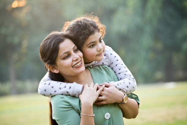 istock Loving mother carrying her daughter at park 1290661966
