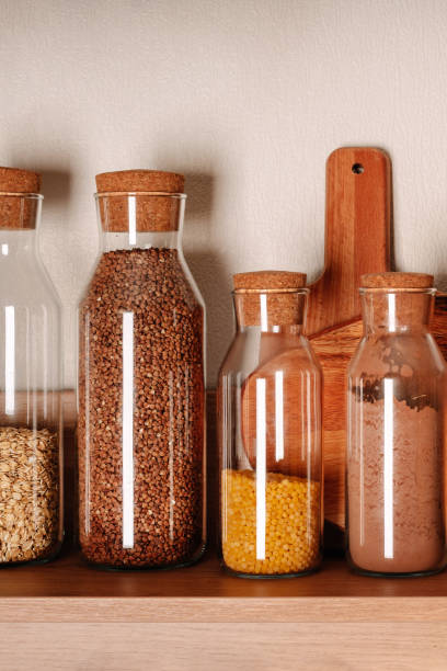 istock Cozy home style modern kitchen with colorful patchwork tiles, spice jars, glass jars with cereals and other kitchen accessories 1290663291