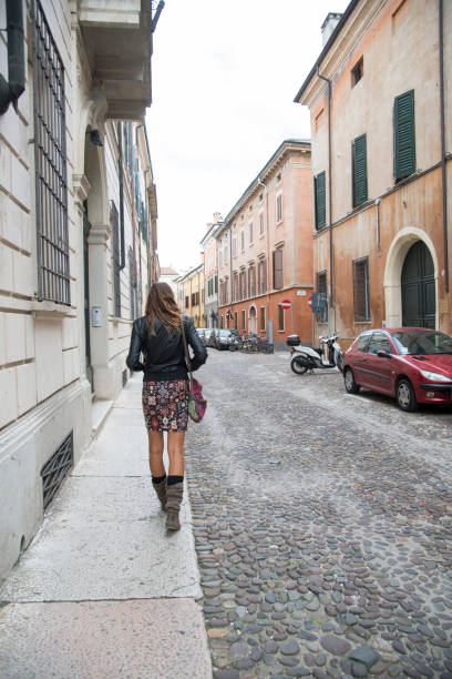 istock young woman walking alone in a city 1290663808