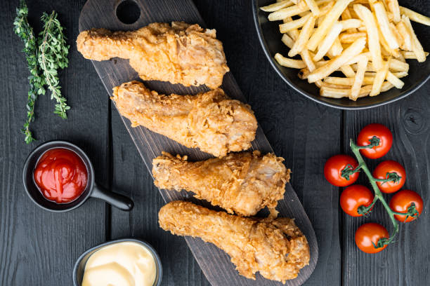 istock Crispy fried chicken on black wooden table, top view 1290664699