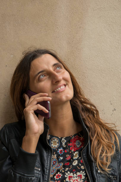 istock beautiful woman using mobile phone outdoor 1290664788