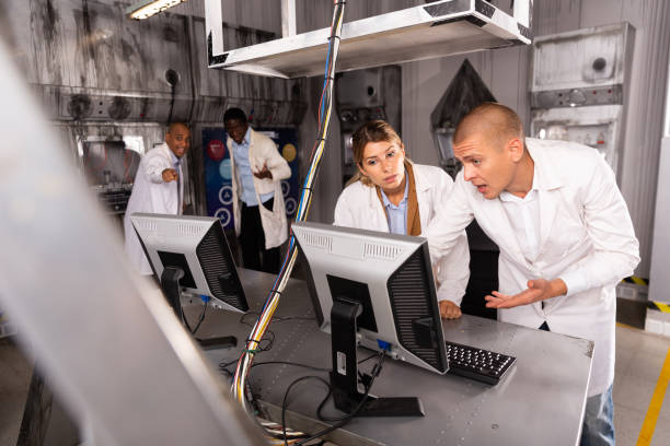 istock Friends trying to solve conundrum in quest room in view as abandoned lab 1290666372