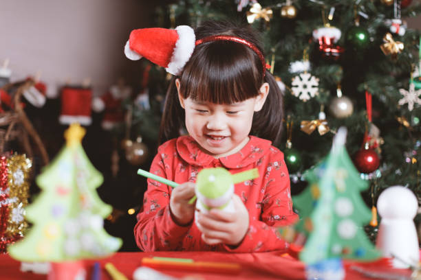 istock young girl making Christmas craft at home 1290666417