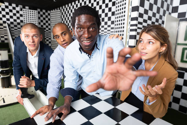 istock Colleagues playing in  chess quest room  during  team building 1290666448