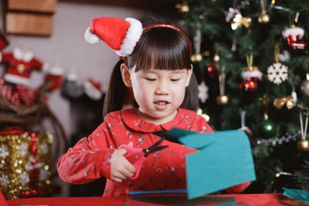 istock young girl making Christmas craft at home 1290666483