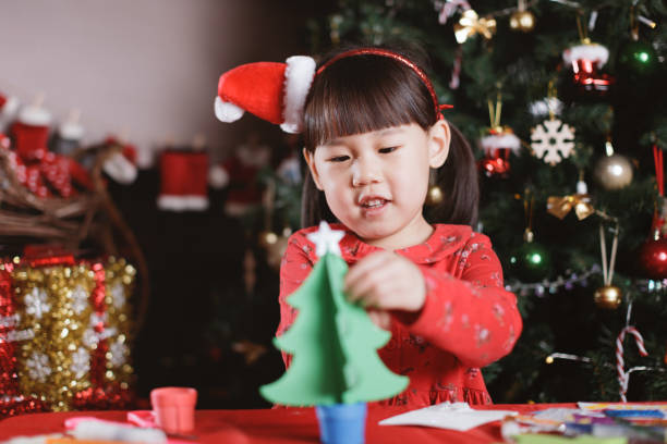 istock young girl making Christmas craft at home 1290666486