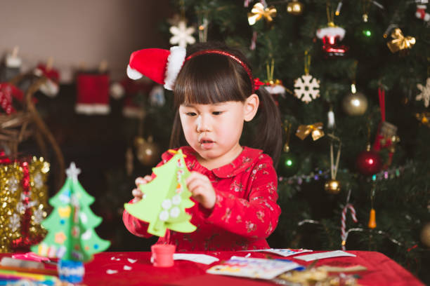 istock young girl making Christmas craft at home 1290666504