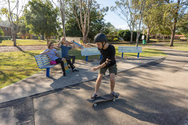 istock Young Men Supporting a Friend Doing Skateboard Tricks 1290667450