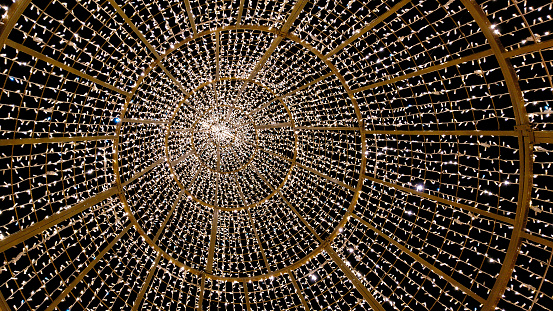 Modern lighting Christmas tree seen from below, inside the tree. Suitable for background purposes.  Lugo city, Galicia, Spain.