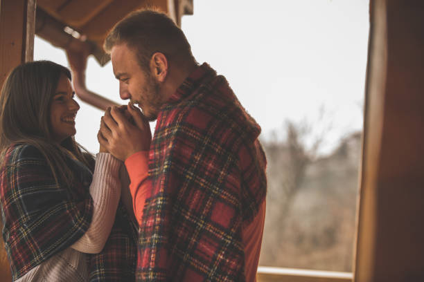 istock Young man warming up his girlfriend's hands while they are relaxing outdoors in the fresh air 1290667541