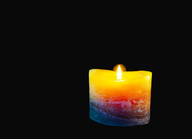 istock Beautiful burning candle with flame,  isolated on black 1290667684