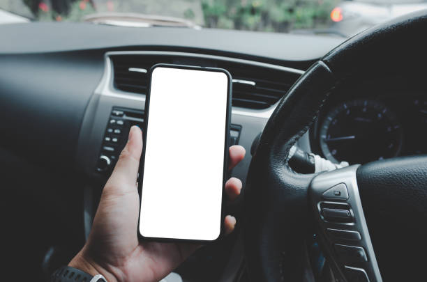 istock man holding the phone in the car 1290667730