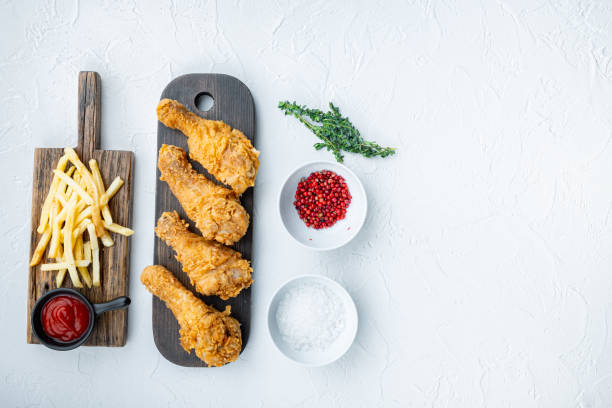 istock Chicken leg breaded on white background, top view, with space for text 1290669085
