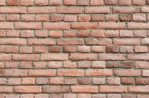 istock Wall of red bricks with cement layers 1290669960