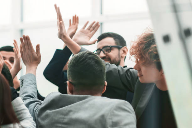 istock business team giving each other high five in new office 1290670576