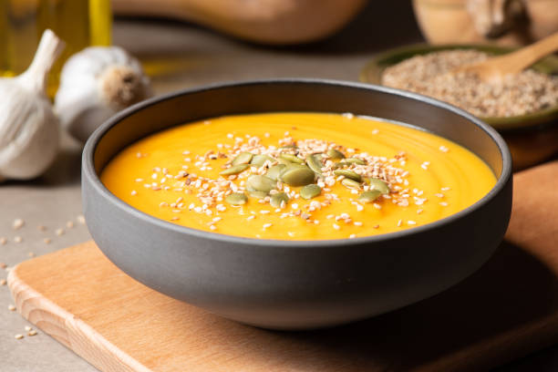 Pumpkin Cream Soup Homemade pumpkin cream soup with pumpkin seeds. This is a ready to eat, organic pumpkin cream for vegan people pumpkin soup photos stock pictures, royalty-free photos & images