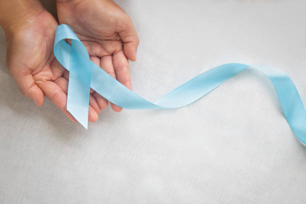 istock Hand holding Light blue color ribbon on white isolated background with copy space. Lymphedema and Prostate Cancer Awareness month symbol. Healthcare medical and insurance concept. Male cancer. 1290673101