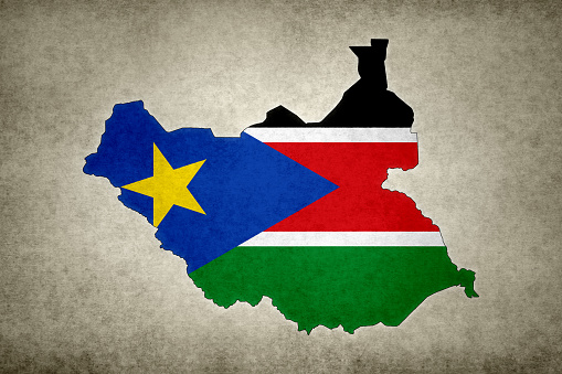 Grunge map of South Sudan with its flag printed within its border on an old paper.