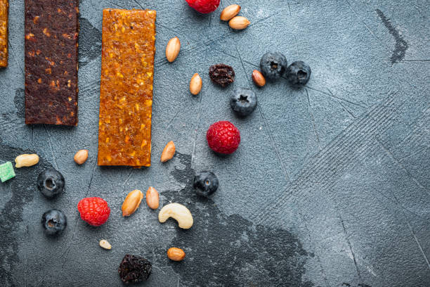 istock Fruit berry and nut energy bars, healthy snack, top view with copy space, on grey background 1290675467