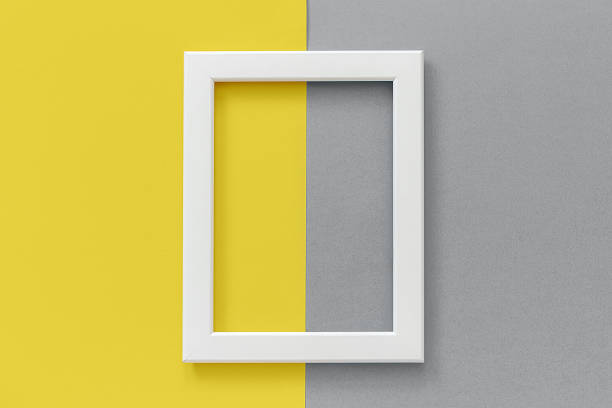 White frame on yellow and gray background. Creative Flat lay Top view Mockup Copy space for text. Trendy colors 2021