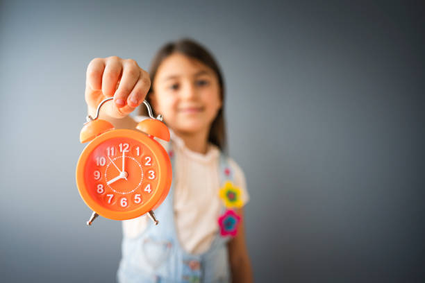 A pink alarm clock on white background