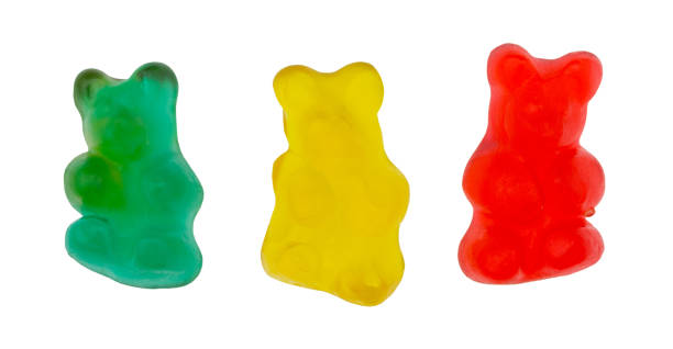istock Three colorful gummi bear sugar candies isolated on a white background. 1290678193