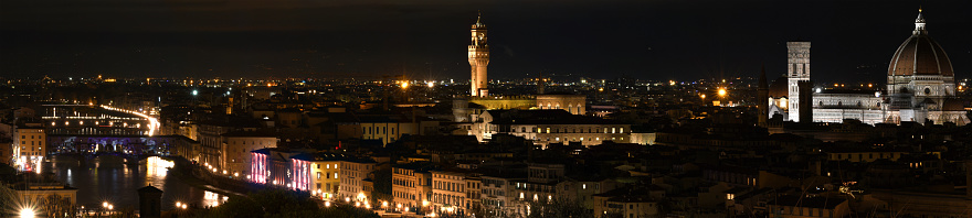 Florence, December 2020: Christmas time. Florence cityscape at evening with special illumination light. Old Bridge, Palace of Cityhall of Florence and Cathedral of Santa Maria del Fiore as seen from Piazzale Michelangelo in Florence, Italy.