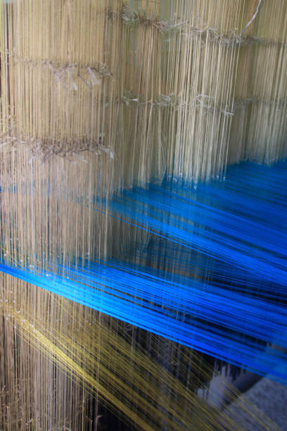 istock Close up of selectively focused silk threads intertwined in a loom 1290679493