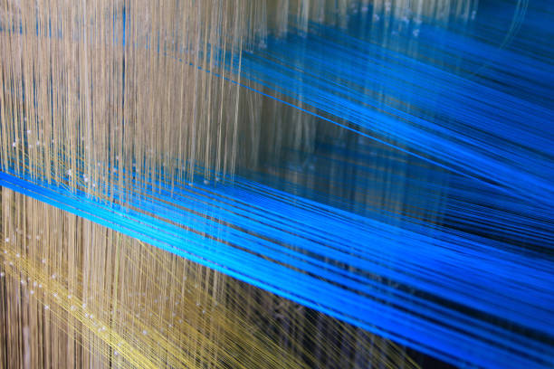 Close up of selectively focused silk threads intertwined in a loom