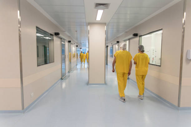 istock Doctors and nurses walking along hospital corridor 1290679736