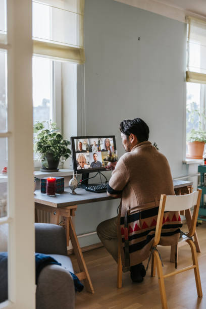 istock Asian man drinks mulled wine during virtual Christmas party 1290679977