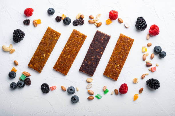 istock Fruit berry and nut energy bars, healthy snack, flat lay, on white background 1290680033