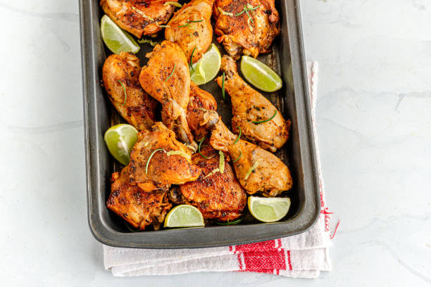 istock Baked Lemon Chicken in a Baking Tray with Lemon and Rosemary 1290681081