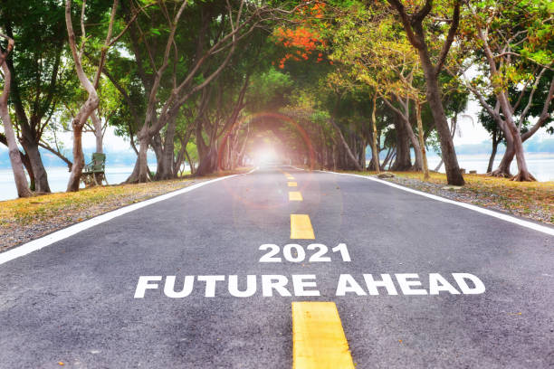 istock New year 2021 and future ahead word with yellow arrow on road surface 1290681545