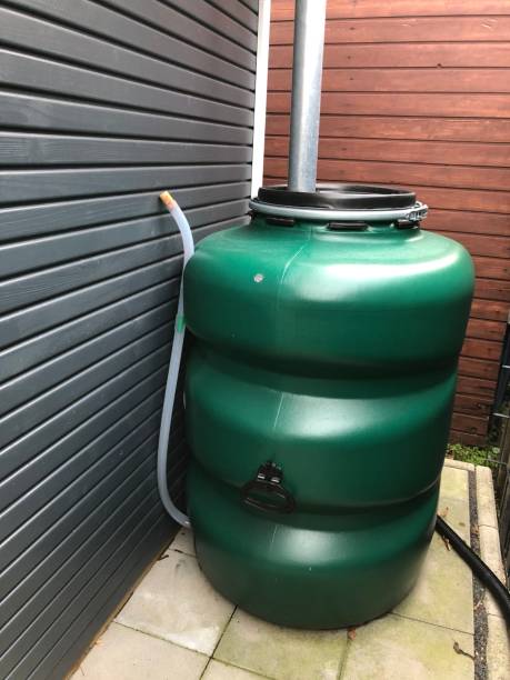 istock Green rain barrel behind the hut 1290682385