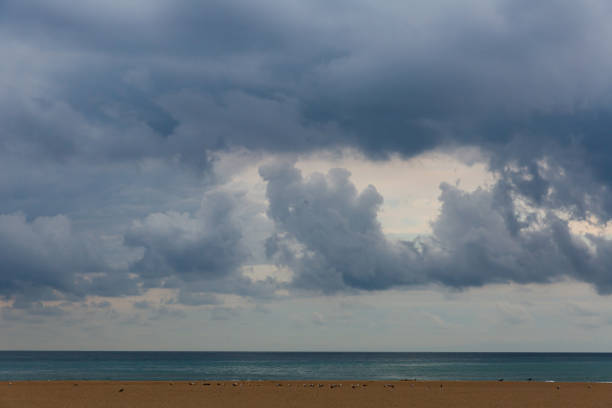 istock Dramatic dark cloudy sky over sea, natural photo background 1290682740