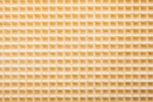 Empty wafer texture as background. Closeup view of golden waffle. Top view with place for text