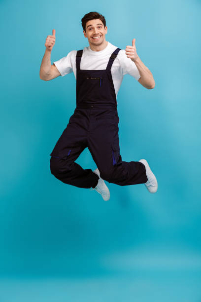 istock Full length image of Cheerful male builder jamping 1290683583
